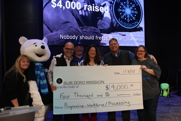 Progressive employees present check to sub zero mission board