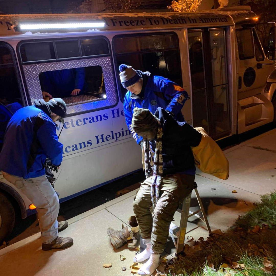 Blue Coats providing a man with some dry warm socks