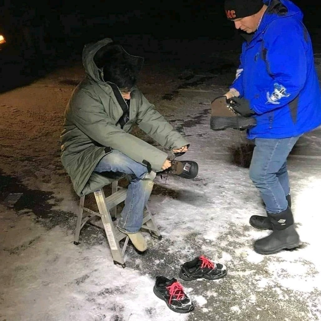 Helping Clients in the field. Here assisting with a pair of new warm boots.